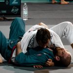 Two martial artists engaged in a Jiu-Jitsu training session, demonstrating techniques and skills.