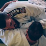Two men practicing ground fighting in Jiu Jitsu